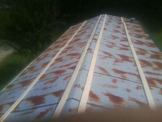 Rusted metal roof panels with new wood purlins before replacement — Storm Damage Roof Repair in Willard by Roofing Brothers